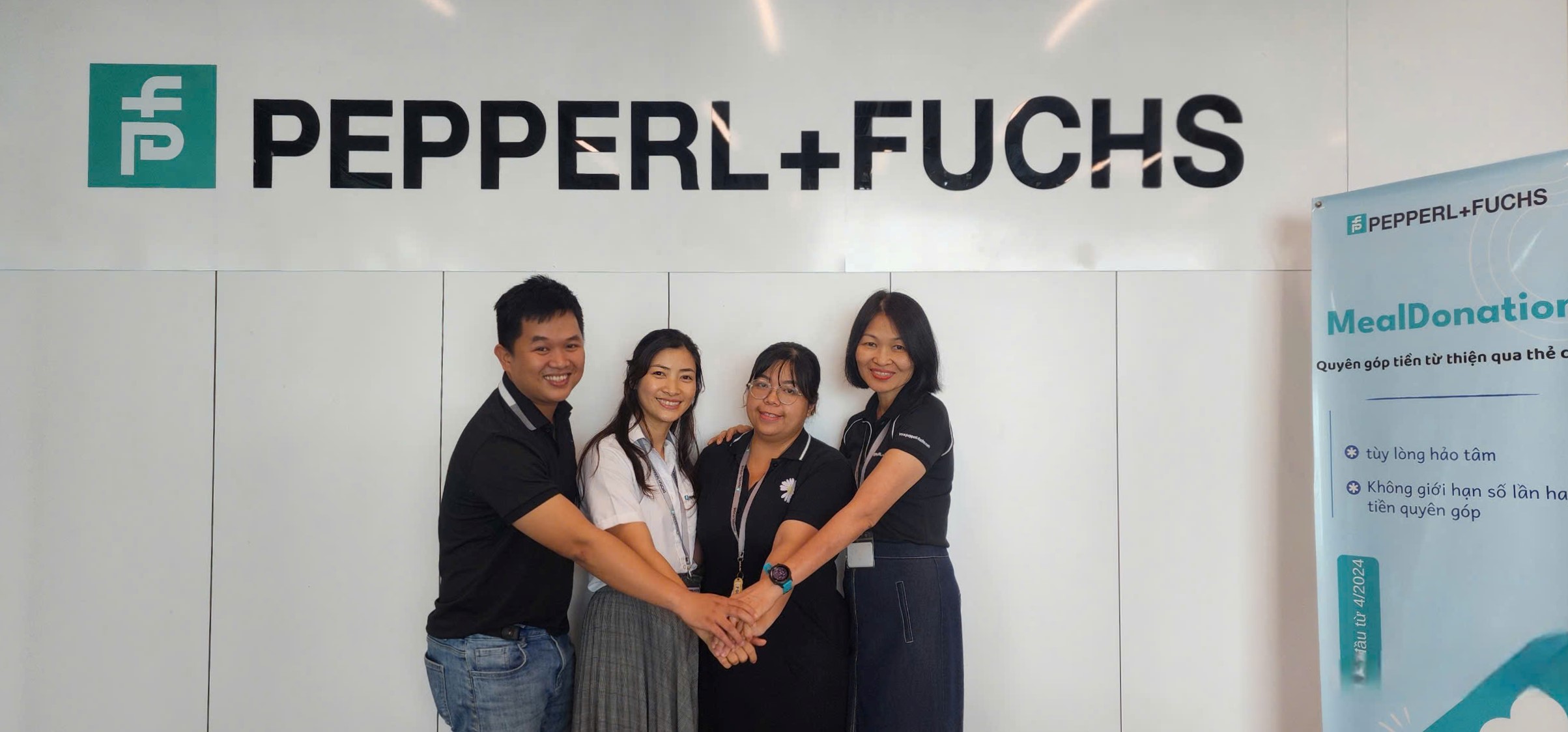 Group photo of the four key individuals of the Social & Charity Committee of Pepperl+Fuchs Vietnam.