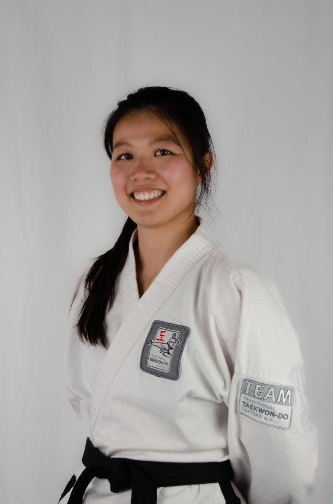 Profile picture of Yun Xia in her white Taekwond-Do uniform with black belt.