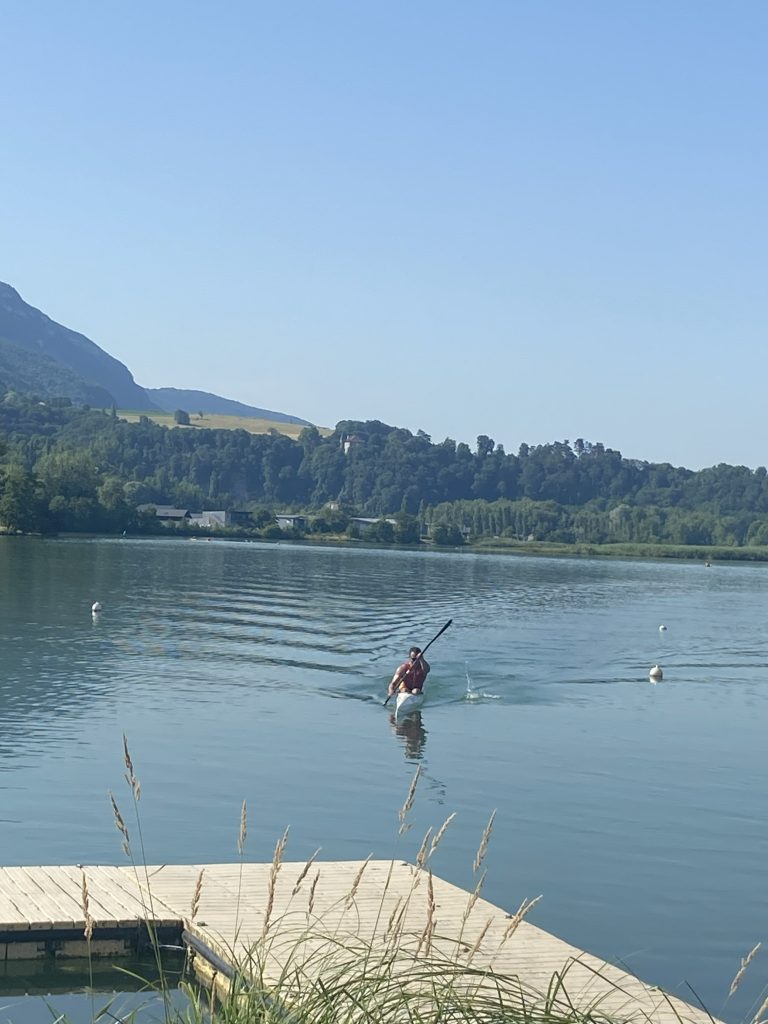 Marco is kayaking in the middle of the lake.